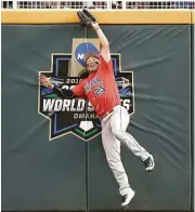 ?? Nati Harnik / Associated Press ?? Arizona right fielder Zach Gibbons goes high at the wall to catch a flyball hit by Coastal Carolina’s Michael Paez in the eighth inning.
