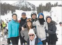  ?? Photograph from Chris Erskine Los Angeles Times ?? CHRIS ERSKINE with his ski entourage (and snowy mustache) in tow on the deck at Canyon Lodge in Mammoth Lakes.