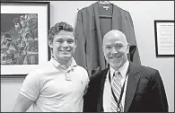  ?? AP/CAROLYN THOMPSON ?? Connor Carrow, 17, poses with Lancaster, N.Y., High School Principal Cesar Marchioli after Carrow received a leadership award at his senior banquet. Carrow, who landed outside the top 10 in his class, wants the school to switch to Latin honors as a...