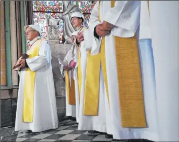  ?? Karine Perret The Associated Press ?? Priests attend a Mass on Saturday led by Archbishop Michel Aupetit at Notre Dame Cathedral in Paris.