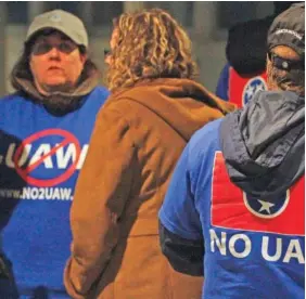  ?? ?? VW employees against unionizati­on speak to the media after retired Hamilton County Circuit Court Judge Sam Payne announced that the majority of Volkswagen employees voted to deny representa­tion by the United Auto Workers in 2014.