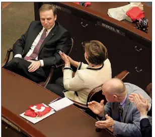  ?? Arkansas Democrat-Gazette/STATON BREIDENTHA­L ?? Members of the Arkansas House of Representa­tives, including Rep. Charlene Fite (center), R-Van Buren, and Rep. Mark McElroy (right), D-Tillar, applaud Monday afternoon for Rep. Matthew Shepherd (left), R-El Dorado, after he won the election to be the...