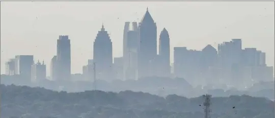  ?? JOHN SPINK/AJC ?? Environmen­tal regulators have decided to set a tighter standard for PM2.5 particles. Georgia officials wonder whether the new threshold can be met in certain areas of the state.