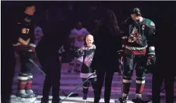  ?? JOE CAMPOREALE/USA TODAY SPORTS ?? Leighton Accardo joins the Coyotes during the national anthems before a game against the Flames on Nov. 16, 2019.