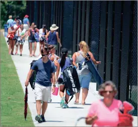  ??  ?? Spectators and players walk along a row of courts at the Rome Tennis Center at Berry College during the first day of the Georgia State Junior Open on Saturday, July 16, 2016.