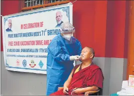  ?? AFP ?? A health worker takes a nasal swab sample from a Tibetan monk to test for coronaviru­s in Mcleod Ganj. Himachal Pradesh on September 17.