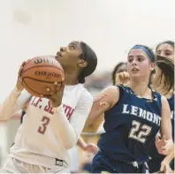  ?? VINCENT D. JOHNSON/DAILY SOUTHTOWN ?? T.F. South’s Tariya Wright, left, looks up for a shot after pulling down an offensive rebound against Lemont during a South Suburban Blue game on Dec. 15.