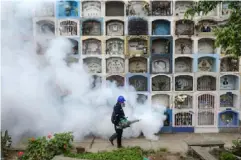  ??  ?? A specialist fumigates the Nueva Esperanza graveyard outside Lima in 2016 to prevent the spread of Zika virus (AFP/Getty)