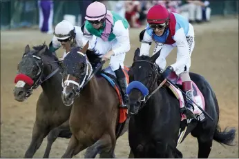  ?? JEFF ROBERSON — THE ASSOCIATED PRESS ?? John Velazquez riding Medina Spirit leads Florent Geroux on Mandaloun and Flavien Prat riding Hot Rod Charlie to win the 147th running of the Kentucky Derby at Churchill Downs, Saturday, May 1, 2021, in Louisville, Ky.