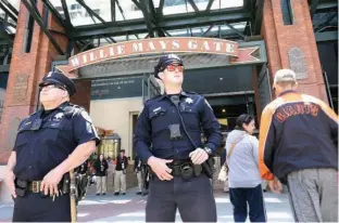  ?? Associated Press ?? San Francisco Police Officers Joe Juarez, left, and Chris Simpson wear body cameras May 13 while patroling outside of AT&T Park before a baseball game between the San Francisco Giants and the Cincinnati Reds in San Francisco. San Francisco is one of...