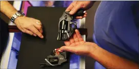  ?? JOE RAEDLE — GETTY IMAGES ?? A customer shops for a handgun at a gun store in Florida.