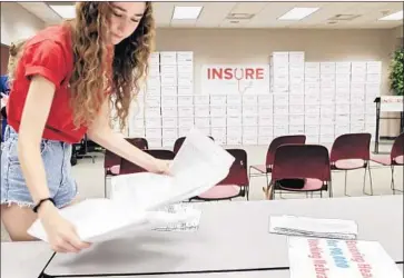  ?? Nati Harnik Associated Press ?? A VOLUNTEER SORTS signed petitions on July 5 in Lincoln, Neb., one of four GOP states where voters have qualified November ballot measures to expand Medicaid coverage. The others are Idaho, Utah and Montana.