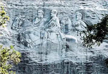  ?? JOHN BAZEMORE/AP ?? The carving depicts Confederat­e figures Stonewall Jackson, Robert E. Lee and Jefferson Davis in Stone Mountain, Ga.