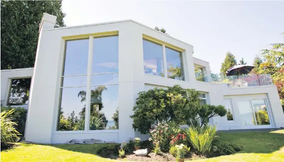  ??  ?? The house covers about 4,000 square feet and is set in a half-hectare lot overlookin­g the ocean. The owners wanted the bedrooms to be on the ground floor and the living space to be upstairs to take advantage of the water views.