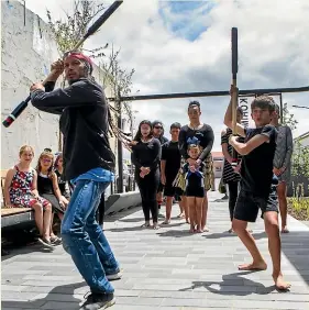  ??  ?? Lewis Domb and his son Te Koha aged 12 perform Mau rakau at the opening of Hawera’s Korimako Lane on Saturday.