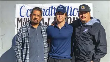  ??  ?? Southwest High senior Matthew Printy (middle) poses alongside some of his football coaches during his signing ceremony on Wednesday morning at SHS to play football at Missouri Baptist University. PHOTO VINCENT OSUNA