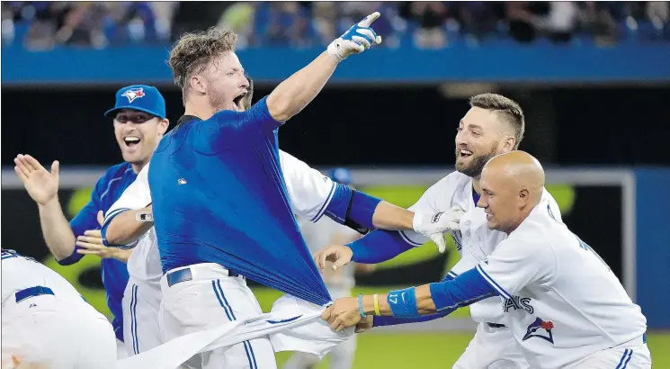  ?? — THE CANADIAN PRESS FILES ?? Toronto’s Josh Donaldson, centre left, is a leading contender for AL MVP. He wouldn’t be a Jay, though, if Alex Anthopoulo­s wasn’t a pesky fact finder.