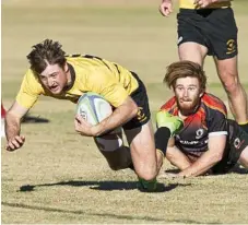  ?? Photo: Nev Madsen ?? TRY TIME: Josh Sayeg of Highfields is left helpless as he watches Sean Cairns cross for a Goondiwind­i try in today’s round-15 Risdon Cup match at Highfields Sport and Recreation Park.