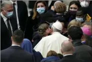  ?? ?? Pope Francis is kissed by a child at the end of his weekly general audience in the Paul VI Hall, at the Vatican, Wednesday.
