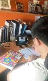  ?? — photos: WONG li Za/the Star ?? Justin’s Math lessons with his teacher and classmates are done via Google Meet.