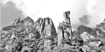  ??  ?? A granite pillar of 128 metres tall that resembles a giant python slithering out of the mountain.