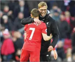  ?? PAUL ELLIS/AFP ?? Liverpool’s manager Jurgen Klopp (right) hugs James Milner after their Premier League match against Burnley at Anfield on Sunday.