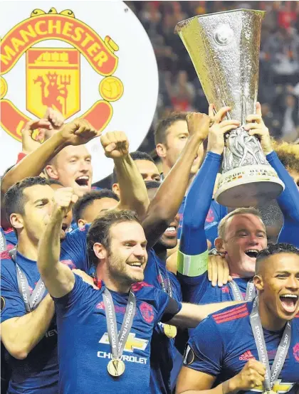  ?? Picture / AP ?? Manchester United’s Wayne Rooney lifts the Europa League trophy.