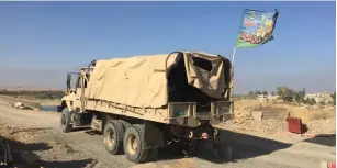  ?? (Seth J. Frantzman) ?? AN IRAQI ARMY TRUCK adorned with a Shi’ite flag transports goods to the 9th Armored Division last year.