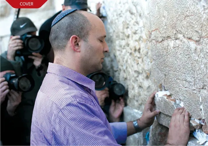  ?? (Marc Israel Sellem/The Jerusalem Post) ?? BENNETT PRAYS at the Western Wall in 2013.