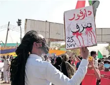  ?? AFP ?? A PROTESTER holds a sign reading ‘Darfur is bleeding’ in Arabic during a protest last year. Darfur has witnessed renewed ethnic violence and deadly clashes between Arab and African tribes over land, resources and grazing paths. |