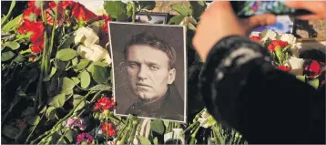  ?? Picture: REUTERS ?? Flowers and portraits of Russian opposition leader Alexei Navalny are placed at the monument to the victims of political repression­s following his death, in Saint Petersburg, Russia February 16, 2024.