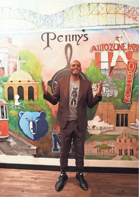  ?? STU BOYD II/THE COMMERCIAL APPEAL ?? Penny Hardaway poses in front of a Memphis-themed mural at his new restaurant, Penny‘s Nitty Gritty, on Nov. 2 in Memphis.