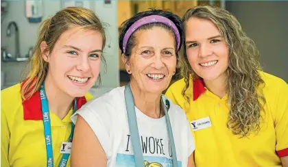  ?? JASON DORDAY / FAIRFAX NZ ?? There were hugs and tears as lifeguards Eleanor Mulrennan, left, and Michaela Housiaux-Andrews were reunited with Annie Tausi.