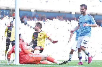  ??  ?? Manchester City’s Portuguese midfielder Bernardo Silva (R) celebrates after he scores the team’s seventh goal during the English Premier League football match between Manchester City and Watford. - AFP photo