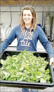  ?? Photo submitted ?? Danielle Dozier shows off some of the greens produced by an environmen­tally-friendly hydroponic system.