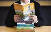  ?? AP ?? Attempted book bannings and restrictio­ns at school and public libraries continue to surge, according to a new report from the American Library Associatio­n.