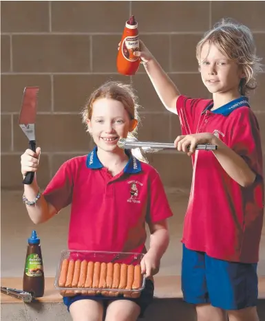  ??  ?? Townsville South State School students Hession, 9, and Charlie Yeo, 9, are all set with democracy sausages for election day. Picture: EVAN MORGAN