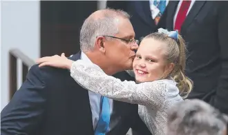  ?? Picture: KYM SMITH ?? Treasurer Scott Morrison kisses his daughter Abbey after delivering his Budget speech at Parliament House in Canberra.