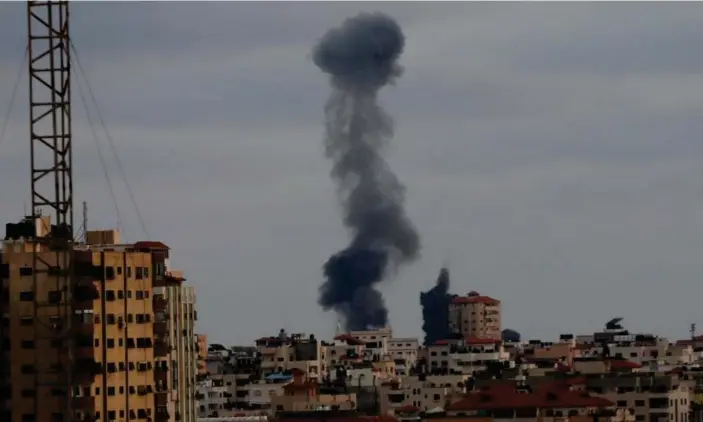  ??  ?? Smoke billows at an industrial area during an Israeli air strike in Gaza earlier on Thursday. The conflict has cost 232 lives in Gaza and 12 in Israel. Photograph: APAImages/Rex/Shuttersto­ck