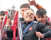  ?? ?? Jubilant John Rankin lifts the SPFL Trust Trophy