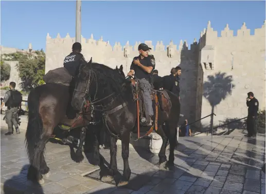  ?? (Reuters) ?? A MOUNTED security patrol stands guard at Damascus Gate.