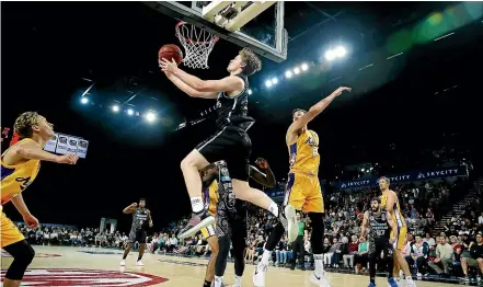  ??  ?? Finn Delany goes for a reverse layup during the Breakers NBL match against Sydney in Auckland yesterday.