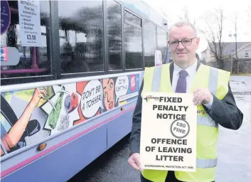  ??  ?? Taking out the trash Councillor McPake gives his backing to the region-wide campaign