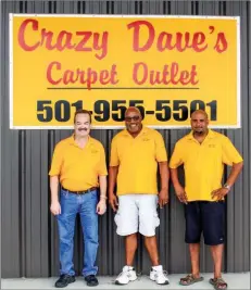  ??  ?? LINDA GARNER-BUNCH/ARKANSAS DEMOCRAT-GAZETTE The team at Crazy Dave’s Carpet Outlet includes, from left, Lance Boykin, manager;KenTurner,president;and HopTurner,warehouse manager.The store employs four work crews to install any kind of flooring.
