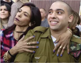  ?? — AP ?? TEL AVIV: Israeli soldier Elor Azaria is embraced by his mother at the start of his sentencing hearing in Tel Aviv, Israel yesterday.