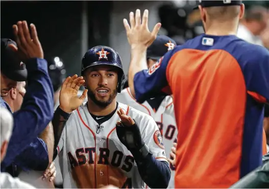 ?? Karen Warren / Staff photograph­er ?? George Springer, who homered earlier, celebrates his run on Carlos Correa’s fifth-inning walk. Springer had three hits, two RBIs and scored twice.