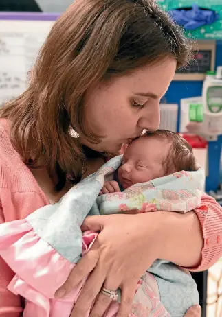  ??  ?? Margaret Boemer cuddles her baby Lynlee Hope, who came into the world on two separate occasions.