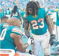  ??  ?? Jay Ajayi thanks tackle Ja'Wuan James, left, and the rest of his offensive line for another 200-plus yard rushing day.