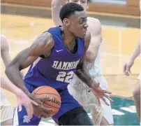  ??  ?? Hammond’s Darrell Reed (22) heads to the basket.