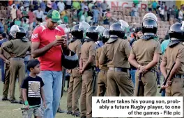  ??  ?? A father takes his young son, probably a future Rugby player, to one of the games - File pic